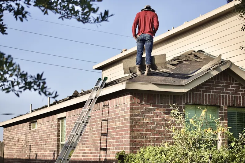 Professional roofer working on a residential roof in Newport